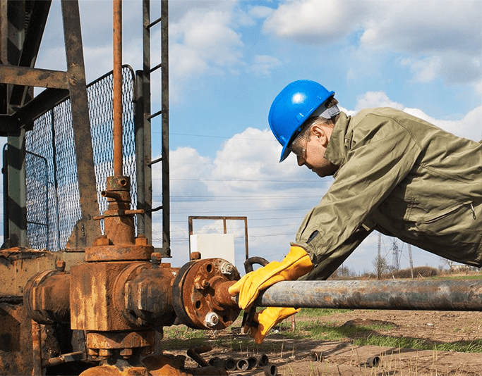 Oilfield technician working on wellsite equipment